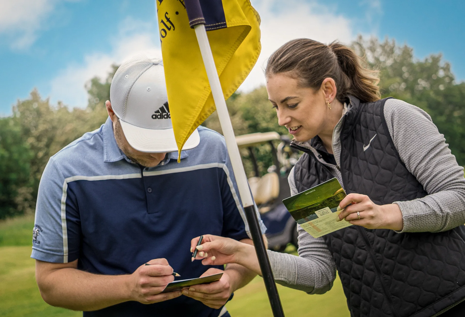 Man and woman looking at a golf scorecard at Wycombe Heights Golf Club in High Wycombe