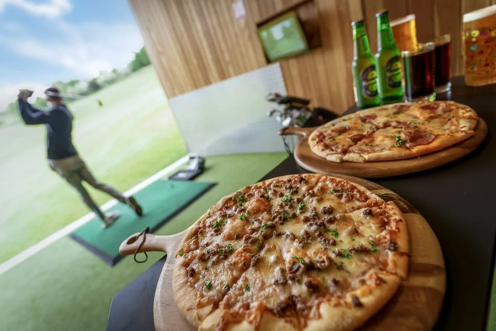 Fresh pizza delivered to a Trackman bay at the driving range High Wycombe